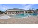 Resort-style community pool with ample seating, covered lounge area, and lush landscaping for relaxation and leisure at 1689 Lake Reserve Dr, Deland, FL 32724