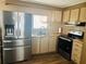 Well-lit kitchen equipped with stainless steel fridge and modern appliances at 212 Rue De Pont, Tavares, FL 32778