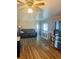 Bright living room showing the updated flooring and a stainless steel refrigerator at 212 Rue De Pont, Tavares, FL 32778