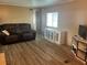 The living room features a plush sofa, modern flooring, and a stylish white media center at 212 Rue De Pont, Tavares, FL 32778