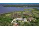 Aerial view of waterfront property with private dock and lush surrounding landscaping at 2189 Old Dixie Hwy, Ormond Beach, FL 32174