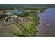 An aerial view shows the home's waterfront location near a large lake at 2189 Old Dixie Hwy, Ormond Beach, FL 32174