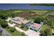 Stunning aerial view of estate home overlooking waterfront with dock and green landscape at 2189 Old Dixie Hwy, Ormond Beach, FL 32174