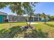 Large backyard featuring mature landscaping, an enclosed patio, and a bright blue two-story home at 2189 Old Dixie Hwy, Ormond Beach, FL 32174