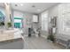 Bright bathroom with double shuttered windows, granite counters, storage, and access to the pool area at 2189 Old Dixie Hwy, Ormond Beach, FL 32174