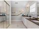 Bathroom features a double sink vanity with granite countertop and a mirrored closet door at 2189 Old Dixie Hwy, Ormond Beach, FL 32174