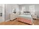 Bedroom with wood flooring, shuttered windows, dresser and mirror at 2189 Old Dixie Hwy, Ormond Beach, FL 32174