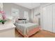 Bright bedroom featuring neutral tones, shuttered windows, and a comfortable bed with pastel accents at 2189 Old Dixie Hwy, Ormond Beach, FL 32174
