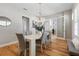 Open-concept dining room with modern chandelier, neutral tones, and hardwood floors at 2189 Old Dixie Hwy, Ormond Beach, FL 32174