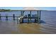 Waterfront dock with seating, dining, and relaxing amenities at 2189 Old Dixie Hwy, Ormond Beach, FL 32174