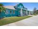 Two-story home featuring a columned front porch, white trim, and manicured landscaping at 2189 Old Dixie Hwy, Ormond Beach, FL 32174