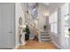 Bright foyer with hardwood floors, stairs, and a stylish console table at 2189 Old Dixie Hwy, Ormond Beach, FL 32174