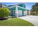Exterior shot of the large three car garage and well-manicured lawn at 2189 Old Dixie Hwy, Ormond Beach, FL 32174