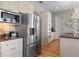 Kitchen with stainless steel refrigerator, granite countertops, microwave, and white cabinets at 2189 Old Dixie Hwy, Ormond Beach, FL 32174