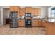 Bright kitchen featuring stainless appliances, tile floors, stone countertops, and light wood cabinetry at 2189 Old Dixie Hwy, Ormond Beach, FL 32174