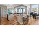 Open kitchen with a center island, bar seating, stainless appliances, and scenic backyard views at 2189 Old Dixie Hwy, Ormond Beach, FL 32174