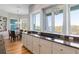 Kitchen with granite countertops, white cabinetry, stainless cooktop, and adjacent dining area with scenic views at 2189 Old Dixie Hwy, Ormond Beach, FL 32174