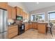 Kitchen with granite counters, stainless appliances, tile floors, breakfast bar, and bright windows at 2189 Old Dixie Hwy, Ormond Beach, FL 32174
