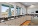 Bright kitchen with large windows offering backyard views, white cabinets, and stainless steel appliances at 2189 Old Dixie Hwy, Ormond Beach, FL 32174