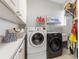 Laundry room with side by side washer and dryer, white cabinets and countertop and an upper shelf at 2189 Old Dixie Hwy, Ormond Beach, FL 32174
