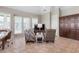 Bright living room featuring neutral tones, tile floors, comfortable seating, and access to outdoor area at 2189 Old Dixie Hwy, Ormond Beach, FL 32174