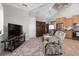 Bright living room with tile floors, vaulted ceiling, TV, comfortable seating, and access to kitchen at 2189 Old Dixie Hwy, Ormond Beach, FL 32174