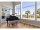 Cozy living room nook with piano and scenic outdoor views through large windows at 2189 Old Dixie Hwy, Ormond Beach, FL 32174
