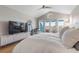 View of main bedroom with hard wood flooring, large tv, and vaulted ceilings at 2189 Old Dixie Hwy, Ormond Beach, FL 32174