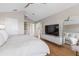Spacious main bedroom featuring vaulted ceilings, modern fan, large mirror and TV at 2189 Old Dixie Hwy, Ormond Beach, FL 32174
