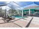 Screened in pool with brick patio and lounge furniture at 2189 Old Dixie Hwy, Ormond Beach, FL 32174