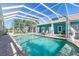 Sparkling pool with screened enclosure featuring lounge chairs and manicured landscaping at 2189 Old Dixie Hwy, Ormond Beach, FL 32174