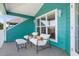 View of a covered porch, featuring brightly painted exterior, and comfortable seating at 2189 Old Dixie Hwy, Ormond Beach, FL 32174