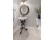 Charming powder room with decorative mirror, unique pedestal sink and base, and tile flooring at 2189 Old Dixie Hwy, Ormond Beach, FL 32174