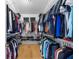Walk-in closet with wood floors, wire shelving, and clothing neatly organized at 2189 Old Dixie Hwy, Ormond Beach, FL 32174