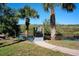 Palm-lined walkway and private foot bridge lead to waterfront on beautiful sunny day at 2189 Old Dixie Hwy, Ormond Beach, FL 32174
