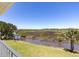 Water view from the property showcasing a walking bridge over marshland and blue skies at 2189 Old Dixie Hwy, Ormond Beach, FL 32174