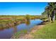 Beautiful waterfront vista with lush, natural surroundings and palm trees at 2189 Old Dixie Hwy, Ormond Beach, FL 32174