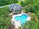 Aerial view showcasing the unique pool area near the clubhouse, surrounded by nature at 27 Winding Creek Way, Ormond Beach, FL 32174