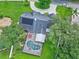 Aerial view of a well-maintained home with a screened-in pool and lush landscaping in a desirable neighborhood at 27 Winding Creek Way, Ormond Beach, FL 32174