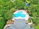 Aerial view of the community pool featuring lounge areas and beautiful landscaping around at 27 Winding Creek Way, Ormond Beach, FL 32174