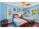 Bright bedroom featuring hardwood floors, ceiling fan and comfortable beds at 27 Winding Creek Way, Ormond Beach, FL 32174