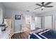 Bright bedroom with ensuite bathroom featuring luxury vinyl flooring, ceiling fan, and ample storage at 27 Winding Creek Way, Ormond Beach, FL 32174