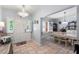 Welcoming entryway with tiled floor leading to the dining area with a chandelier and shuttered windows at 27 Winding Creek Way, Ormond Beach, FL 32174