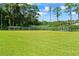 A large green sports field with covered picnic areas surrounded by lush trees at 27 Winding Creek Way, Ormond Beach, FL 32174