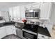 Kitchen with modern stainless steel appliances and white subway tile backsplash at 27 Winding Creek Way, Ormond Beach, FL 32174