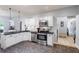 Modern kitchen with white cabinets, stainless appliances, and a view into the hallway at 27 Winding Creek Way, Ormond Beach, FL 32174