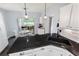 Open kitchen with black countertop, white cabinets, and patio at 27 Winding Creek Way, Ormond Beach, FL 32174