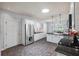 Spacious kitchen with stainless steel appliances, black countertops, and a bright skylight at 27 Winding Creek Way, Ormond Beach, FL 32174
