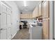 Well-lit laundry room with built-in storage and modern washer and dryer at 27 Winding Creek Way, Ormond Beach, FL 32174