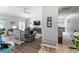 Bright and airy living room with gray sofas, wood floors, high ceilings, and backyard access at 27 Winding Creek Way, Ormond Beach, FL 32174